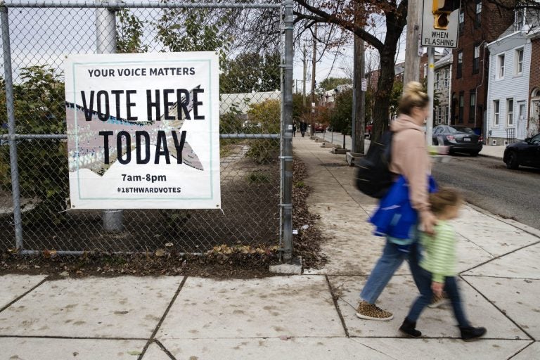 Pedestrians walk past a polling station on Election Day, Tuesday, Nov. 5, 2019 in Philadelphia. (Matt Rourke/AP Photo)