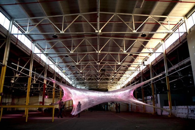 Industrial artists Numen/For Use spin a cocoon of suspended tunnels inside an unused warehouse. (Kimberly Paynter/WHYY)