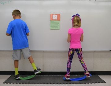 Two fourth-graders rock side to side while doing math equations at Charles Pinckney Elementary School's 