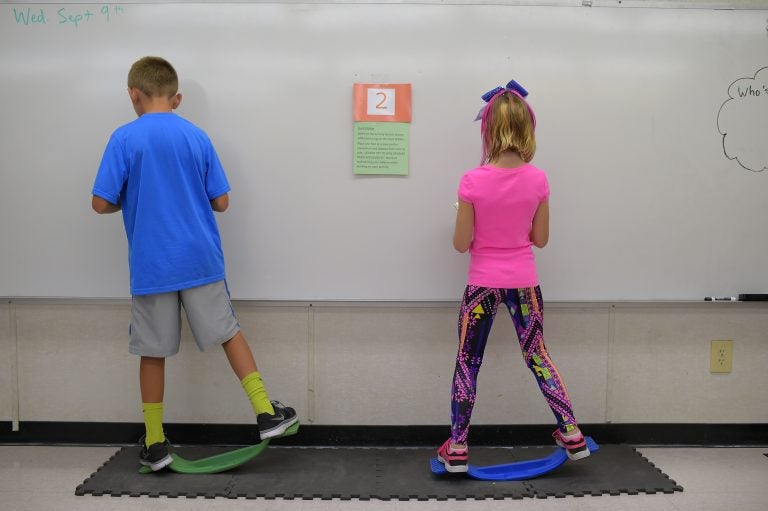 Two fourth-graders rock side to side while doing math equations at Charles Pinckney Elementary School's 