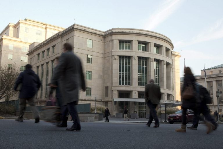 People walk by the Pennsylvania Judicial Center Tuesday, Dec. 8, 2015, at the state Capitol in Harrisburg.