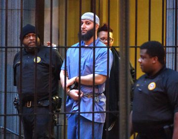 Officials escort convicted killer Adnan Syed, subject of the Serial podcast, from a courthouse in Baltimore in February 2016. (Karl Merton Ferron/Baltimore Sun/Tribune News Service via Getty Images)