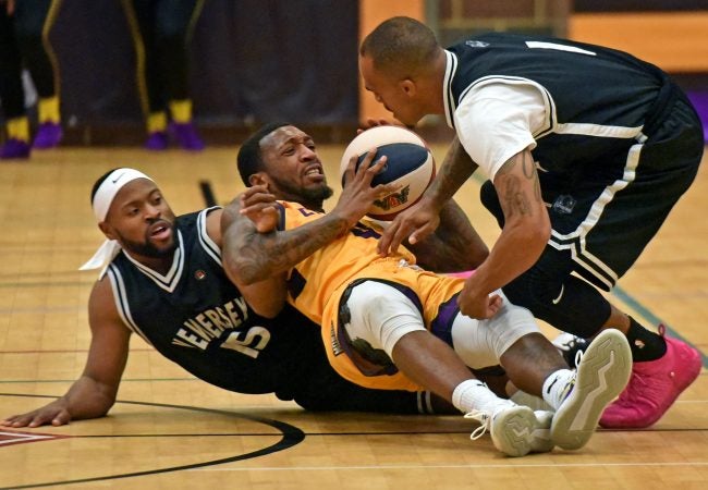 At a November 10 game against the Jersey Express, Camden Monarch Isaiah Graves fights for the ball. (April Saul for WHYY)