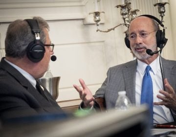 Pennsylvania Gov. Tom Wolf, right, speaks with Scott LaMar, host of WITF's Smart Talk, during a live broadcast at the Governor's Residence in Harrisburg on Dec. 11, 2019. (Joanne Cassaro/WITF)