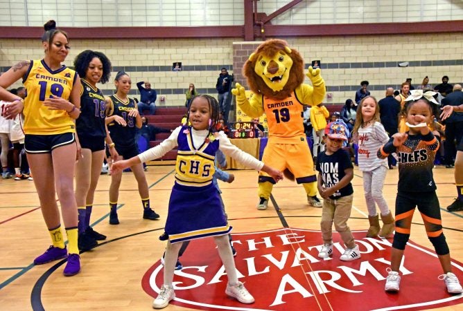 On December 8, Camden Monarchs dancers mix it up with Camden High cheerleaders at halftime of a game against the New York Elite Kings. (April Saul for WHYY)