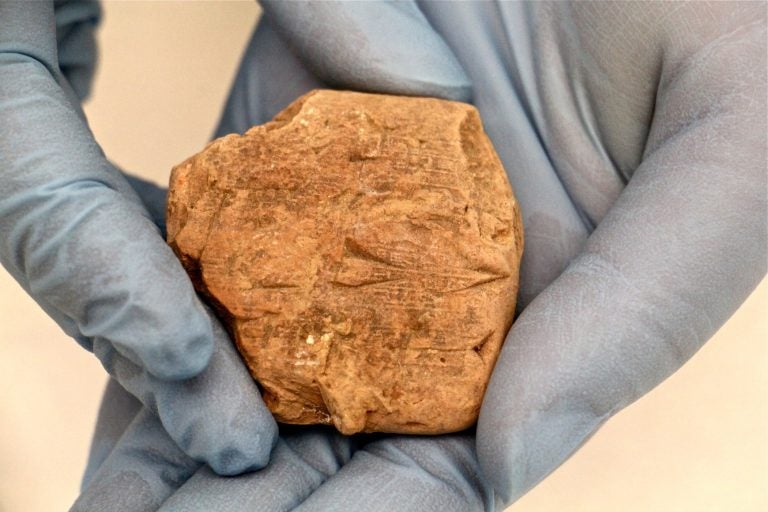 A fragment of clay tablet at the Penn Museum carries information about a business transaction that took place in Ur about 4,000 years ago. (Emma Lee/WHYY)