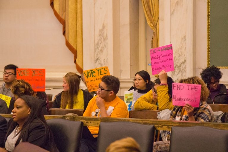 Activists urge City Council members to vote to end the 10-year property tax abatement. (Kimberly Paynter/WHYY)