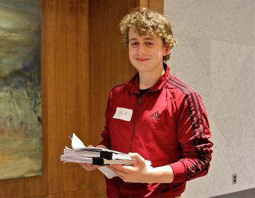 Jack DiPrimio, 17, from upper Darby, holds a draft of the PA democrat delegate selection plan. He hopes to become an Elizabeth Warren delegate. (Ximena Conde/WHYY)