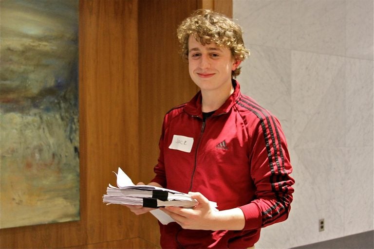 Jack DiPrimio, 17, from upper Darby, holds a draft of the PA democrat delegate selection plan. He hopes to become an Elizabeth Warren delegate. (Ximena Conde/WHYY)