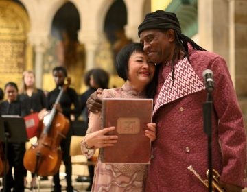 Hannibal Lokumbe dedicates Children of the Fire performance to Napalm Girl Dr. Kim Phuc and composer Hannibal Lokumbe hug during a concert that includes Lokumbe's composition