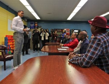 Basketball starr Tobias Harris speaks with a group of Black male teachers at Bethune Elementary School. (Emma Lee/WHYY)