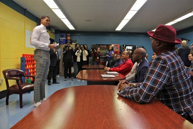 Basketball starr Tobias Harris speaks with a group of Black male teachers at Bethune Elementary School. (Emma Lee/WHYY)