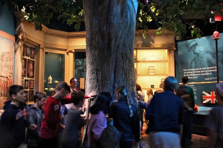 The exhibit room that houses the Liberty Tree at the Museum of the American Revolution is softly lit and full of tactile experiences, but the hubbub can be too much for some children with autism. (Emma Lee/WHYY)