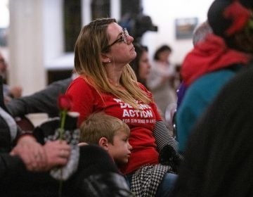 Joyce Pickles of Moms Demand Action sits with her son Dominic, 6, during a vigil for gun violence victims at Broad Street Ministry on Wednesday, December 11, 2019. (Kriston Jae Bethel for WHYY)