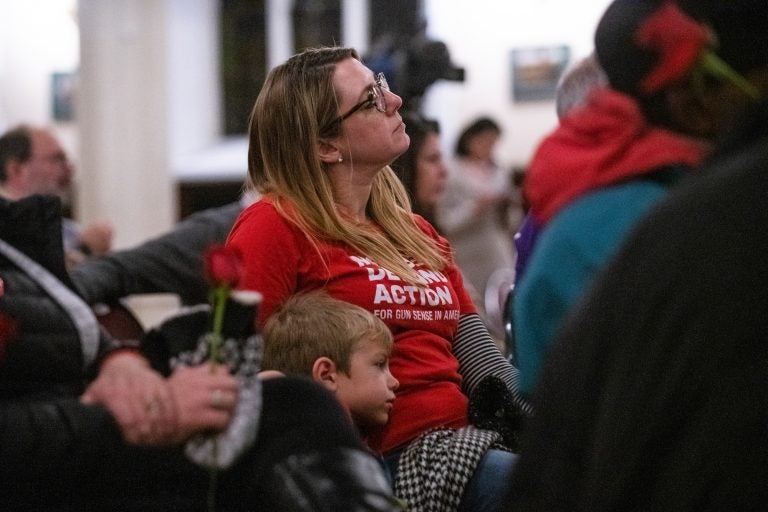 Joyce Pickles of Moms Demand Action sits with her son Dominic, 6, during a vigil for gun violence victims at Broad Street Ministry on Wednesday, December 11, 2019. (Kriston Jae Bethel for WHYY)