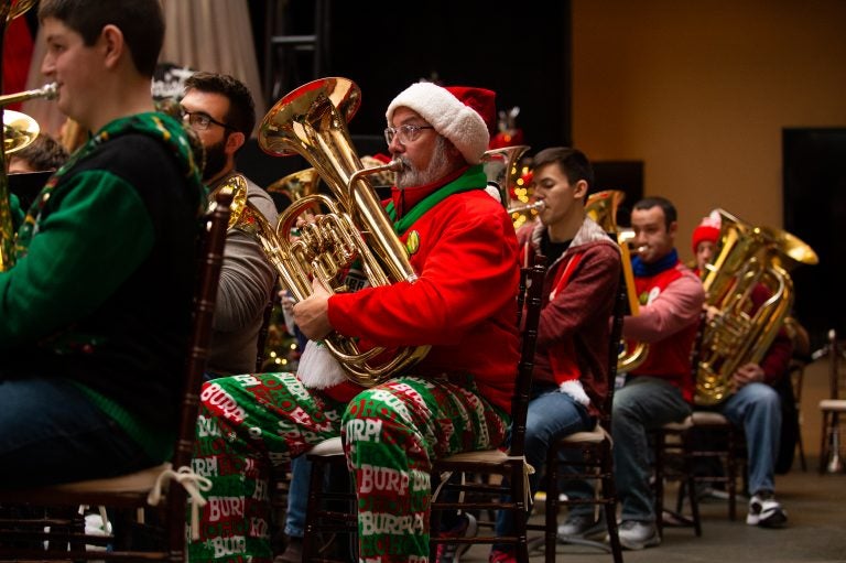 An ensemble of 100 tuba, sousaphone and euphonium players from the region, perform a TubaChristmas concert. (Kriston Jae Bethel for WHYY)