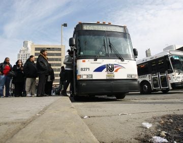 Passengers board an NJ Transit bus in Camden, N.J. (Mel Evans/AP Photo)