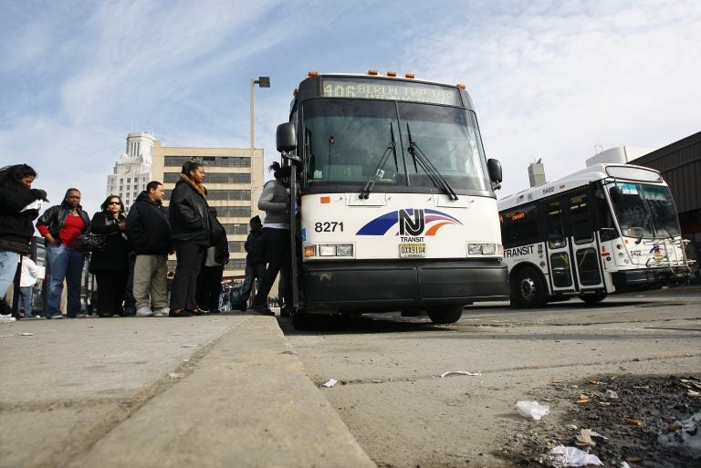 Passengers board an NJ Transit bus in Camden, N.J. (Mel Evans/AP Photo)