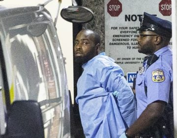 Police take shooting suspect, Maurice Hill, into custody after an hourslong standoff with police, that wounded several police officers, in Philadelphia early Thursday, Aug. 15, 2019. (Elizabeth Robertson/The Philadelphia Inquirer via AP)