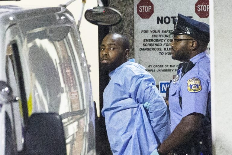 Police take shooting suspect, Maurice Hill, into custody after an hourslong standoff with police, that wounded several police officers, in Philadelphia early Thursday, Aug. 15, 2019. (Elizabeth Robertson/The Philadelphia Inquirer via AP)
