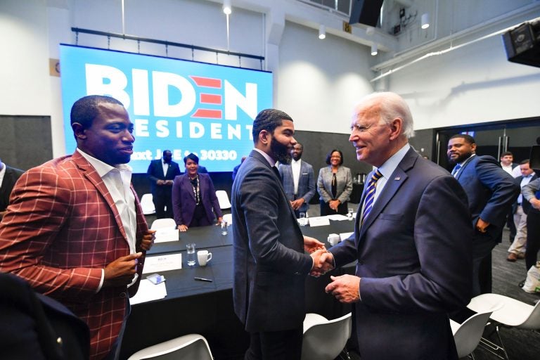 In this Nov. 21, 2019, file photo, Democratic presidential candidate former Vice President Joe Biden, right, walks around a table meeting with an assembly of Southern black mayors including Mississippi Mayor Chokwe Lumumba and Virginia Mayor Levar Stoney, left, in Atlanta. Biden is leading the most diverse presidential field in history among black voters. (AP Photo/John Amis, File)