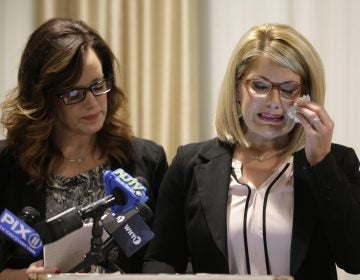 As Patty Fortney-Julius, left, offers support, her sister Lara Fortney McKeever cries as she speaks to reporters during a news conference in Newark, N.J., Monday, Dec. 2, 2019. The two sisters from Pennsylvania are suing the Archdiocese of Newark and the Diocese of Harrisburg, Pennsylvania. They allege clergy in Newark knew a priest had sexually abused children before he moved to Harrisburg and abused them and their sisters for years. Lawsuits alleging sexual abuse by Roman Catholic clergy are taking center stage in New Jersey as the state's relaxation of statute of limitations rules takes effect. (Seth Wenig/AP Photo)