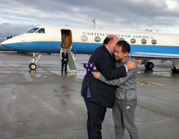 This photo provided by U.S. Embassy Switzerland,  Edward McMullen greets Xiyue Wang in Zurich, Switzerland on Saturday, Dec. 7, 2019.  In a trade conducted in Zurich, Iranian officials handed over Chinese-American graduate student Xiyue Wang, detained in Tehran since 2016, for scientist Massoud Soleimani, who had faced a federal trial in Georgia.  (U.S. Embassy Switzerland via AP)
