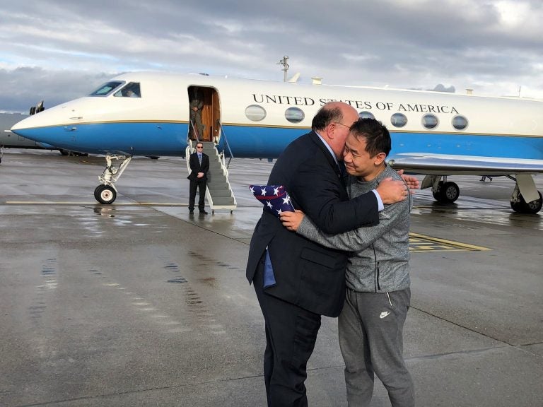 This photo provided by U.S. Embassy Switzerland,  Edward McMullen greets Xiyue Wang in Zurich, Switzerland on Saturday, Dec. 7, 2019.  In a trade conducted in Zurich, Iranian officials handed over Chinese-American graduate student Xiyue Wang, detained in Tehran since 2016, for scientist Massoud Soleimani, who had faced a federal trial in Georgia.  (U.S. Embassy Switzerland via AP)