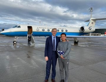 This photo provided by the U.S. State Department, U.S. special representative for Iran, Brian Hook stands with Xiyue Wang in Zurich, Switzerland on Saturday, Dec. 7, 2019.  In a trade conducted in Zurich, Iranian officials handed over Chinese-American graduate student Xiyue Wang, detained in Tehran since 2016, for scientist Massoud Soleimani, who had faced a federal trial in Georgia. (U.S. State Department via AP)