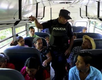 A policeman checks IDs as part of a routine patrol at the border crossing with Guatemala, La Hachadura, El Salvador. (Eduardo Verdugo/AP Photo)