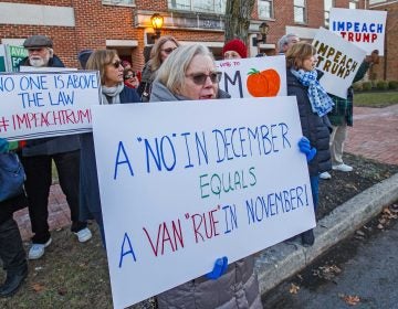 Rebecca Harlan, Ventnor held her sign up Thursday, Dec. 12, 2019, near the Mays Landing, N.J., office of Congressman Jeff Van Drew because of Van Drew no vote on impeachment. (Craig Matthews/The Press of Atlantic City via AP)