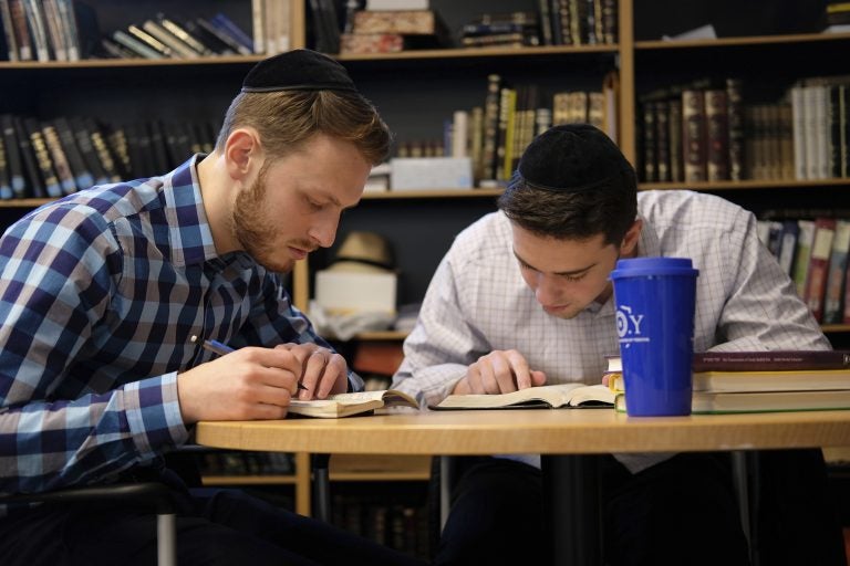 Yeshiva University students Aaron Heideman, (left), and Marc Shapiro study in the university's library in New York, Thursday, Dec. 12, 2019. They praised President Donald Trump's executive order to expand the scope of potential anti-Semitism complaints on U.S. college campuses. They said they worry that friends attending other universities might be targeted by anti-Semitic attacks and that this could help protect them. (Luis Andres Henao/AP Photo)