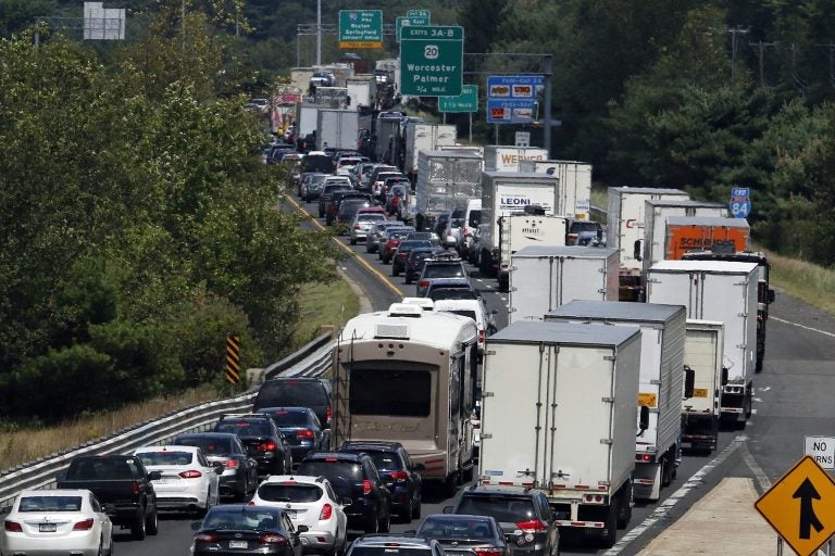 FILE - In this Aug. 12, 2016, file photo, traffic crawls eastbound on Interstate 84 in Sturbridge, Mass., after an overnight accident involving two tractor-trailers on the Massachusetts Turnpike. An alliance of Northeast and mid-Atlantic states are working on a pact aimed at lowering carbon emissions from cars, trucks and other means of transportation. A draft version of the agreement, known as the Transportation and Climate Initiative, was released Tuesday, Dec. 17, 2019. (Bill Sikes/AP Photo)