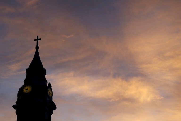 Clouds are lit by the rising sun over St. Augustine Roman Catholic Church in Philadelphia.