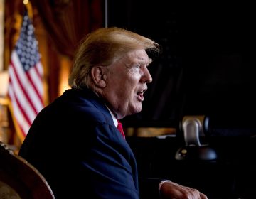 FILE - In this Dec. 24, 2019 photo, President Donald Trump speaks to members of the media following a Christmas Eve video teleconference with members of the military at his Mar-a-Lago estate in Palm Beach, Fla. (AP Photo/Andrew Harnik)