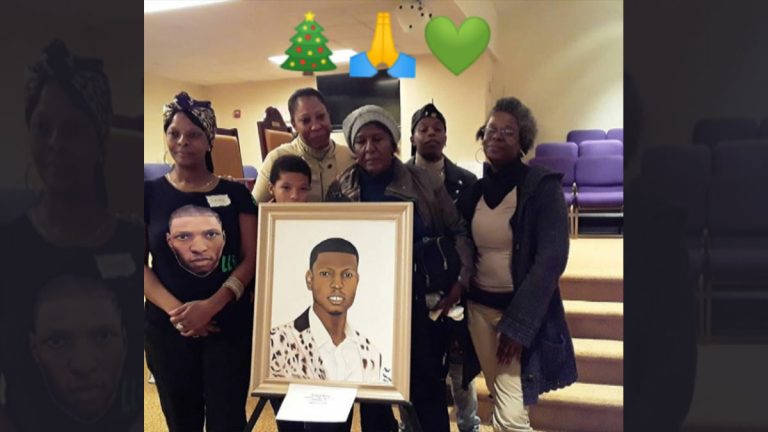 Members of Virgil's family picking up a donated portrait of him this December. (Courtesy of Sandy Ross)