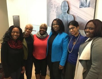 Former refugees joined advocates at the signing ceremony. From left, Sophie Marie Namugenyi, director of support services at Jewish Family Services; Saybah Wolokolie; Ajawavi J. Ajavon; Lourena Gboeah, refugee from Liberia; Padmaja Charya, refugee therapist with JFS; and Jenevive Newman, JFS refugee case manager. (Mark Eichmann/WHYY)