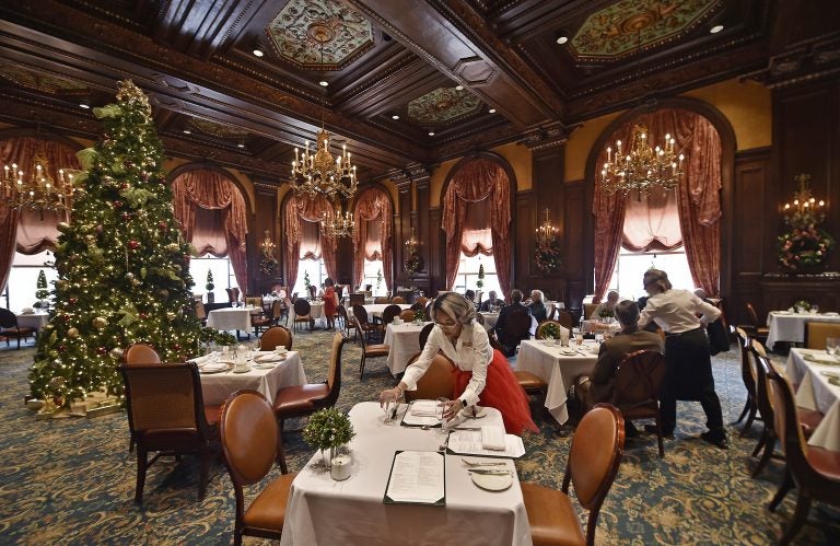 Sheila Marlowe, a hostess at the Green Room for 13 years and counting, sets up a table during lunch on Monday, Dec. 23, 2019, at the Hotel DuPont in downtown Wilmington, Delaware. (Butch Comegys for WHYY)