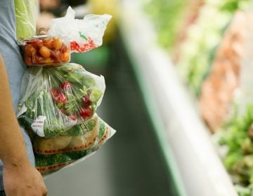 A man buys groceries in a supermarket.