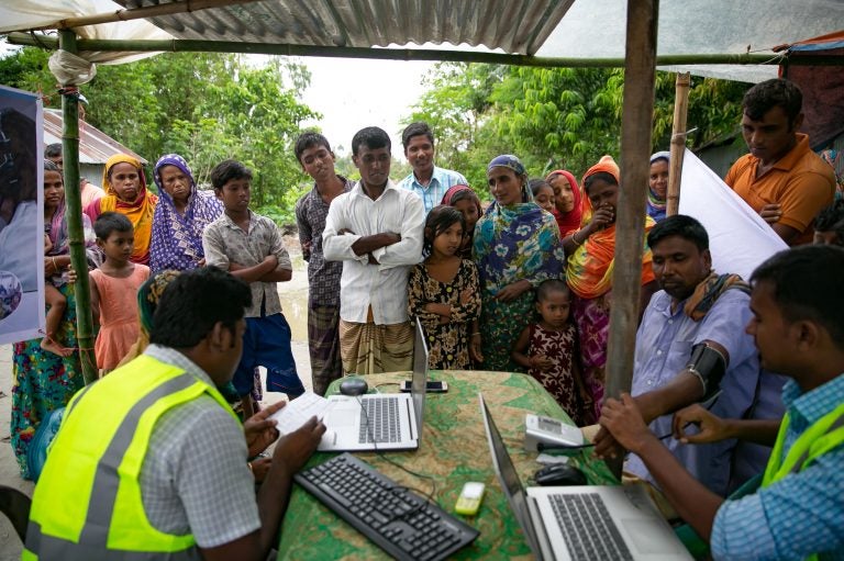 Patients line up for remote health consultation sessions on a remote island near Rangpur, Bangladesh. (Allison Joyce for NPR)