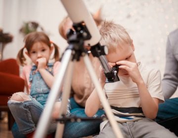 child with telescope