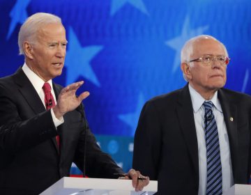 Democratic presidential candidate former Vice President Joe Biden, left, speaks as Democratic presidential candidate Sen. Bernie Sanders, I-Vt., listens during a Democratic presidential primary debate, Wednesday, Nov. 20, 2019, in Atlanta. (AP Photo/John Bazemore)