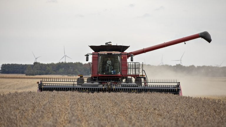 A farmer operates a combine to harvest soybeans in Wyanet, Ill. Farmers got more than $22 billion in government payments in 2019. It's the highest level of farm subsidies in 14 years. (Bloomberg/Bloomberg via Getty Images)