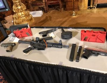 Guns, including ones made through DIY kits, are displayed on a table in the Governor's Reception Room of the state Capitol on Dec. 16, 2019. (Ed Mahon/PA Post)