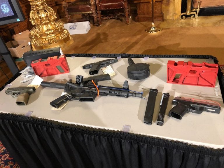 Guns, including ones made through DIY kits, are displayed on a table in the Governor's Reception Room of the state Capitol on Dec. 16, 2019. (Ed Mahon/PA Post)