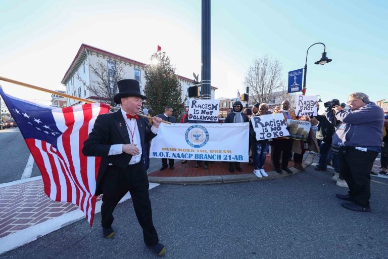 Jack Schreppler, Hummers Parade 'Grand Marshal for life' walks past protesters after greeting them during the Hummers Parade. (Saquan Stimpson for WHYY)