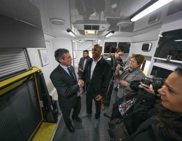 Tyrone Mathis (right) and Del. Gov. John Carney (left) shake hands after touring 