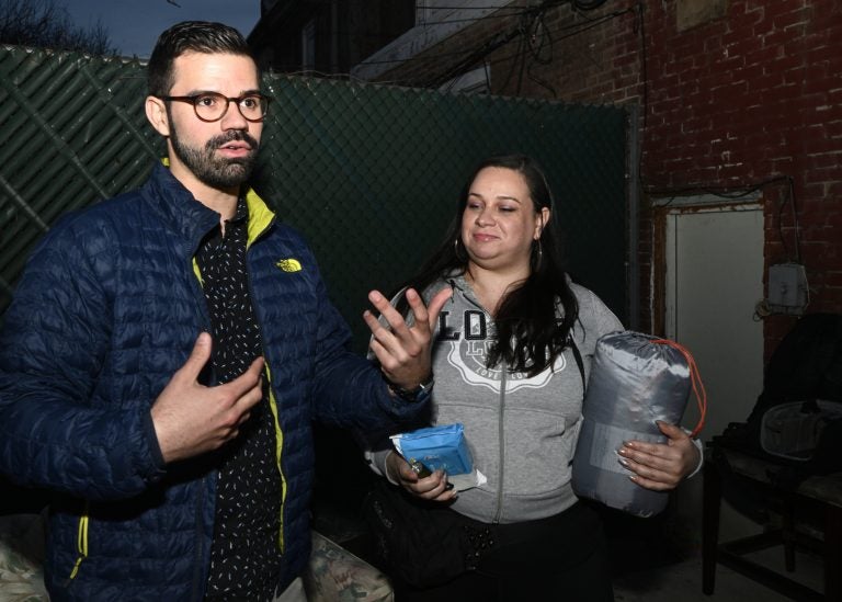 Activist and community organizer Adrian Rivera-Reyes and Vanessa Maria Graber pack emergency items to be donated as a disaster relief package, during a meeting of Philly Boricuas, on Saturday, in North Philadelphia. (Bastiaan Slabbers for WHYY)