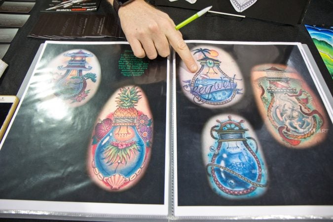 Steven Martin Jr. once saw a light bulb terrarium which inspired his popular light bulb tattoo. (Kimberly Paynter/WHYY)