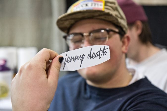 Eric Seamans is receiving the words “Jenny Death,” an album title from his favorite band, the Death Grips. (Kimberly Paynter/WHYY)